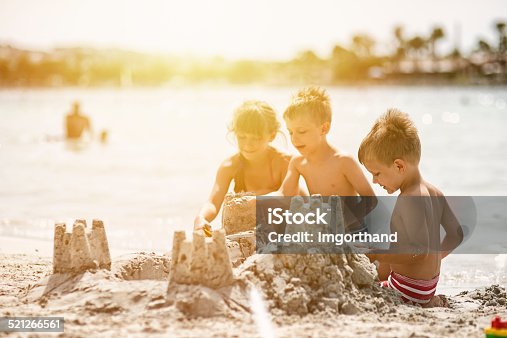 istock Kids building a sandcastle 521266561