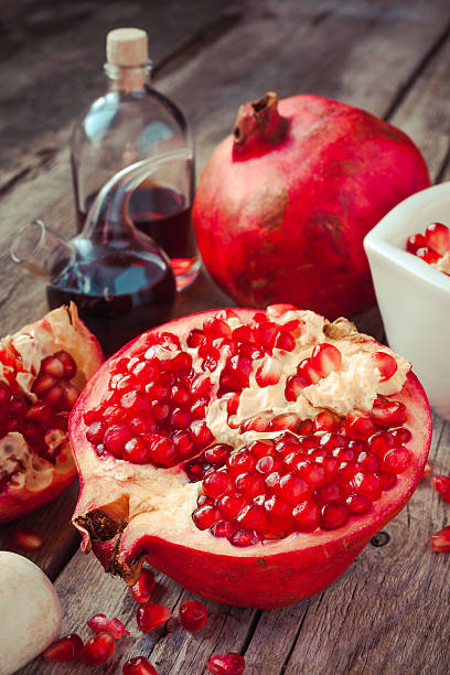 istock Pomegranate and bottles of essence or tincture on table 521266827