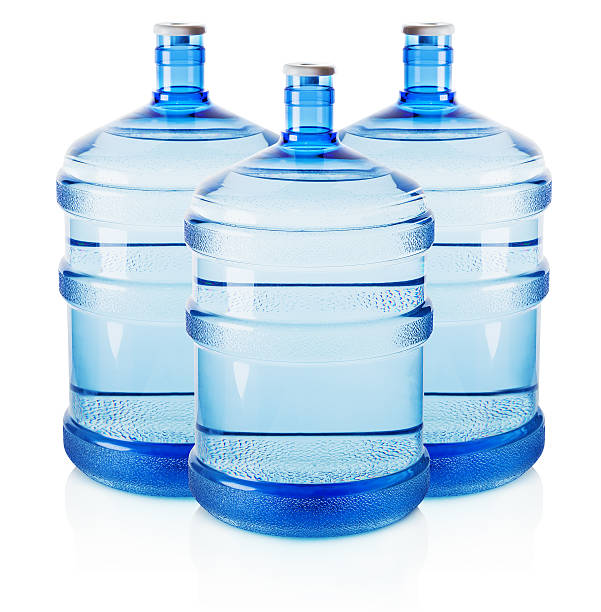 istock Three big bottles of water isolated on the white background 521267419