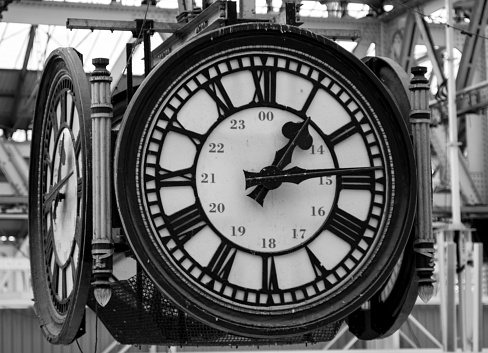 black and white image of a station clock