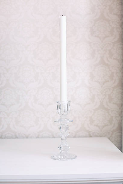 istock white candle in a glass candlestick 521269316