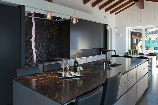 Interior of a loft, kitchen with marble counter top, modern design