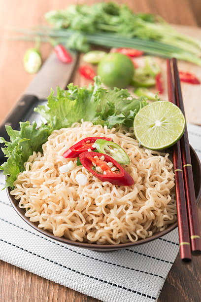 istock chilli on instant noodles in bowl and vegetable background 521271866