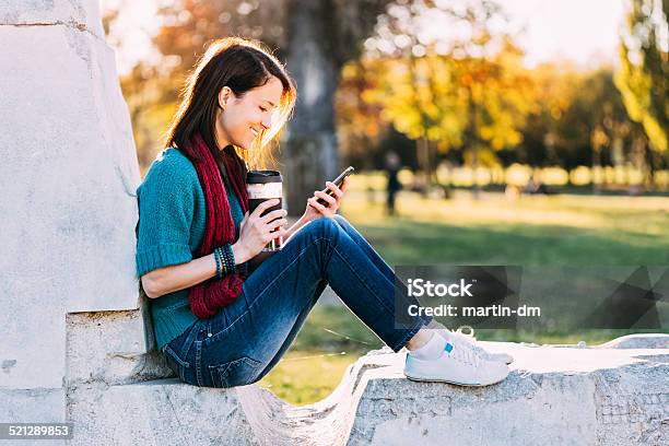 Girl With Phone In The Park Stock Photo - Download Image Now - 20-29 Years, Adult, Adults Only