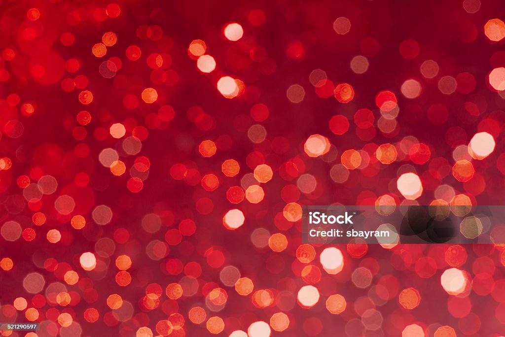 Defocused christmas lights background Photo showing a defocused image of coloured Christmas lights sparkling against a red background. This image is designed to be suitable for a background or similar usage.  Christmas Stock Photo
