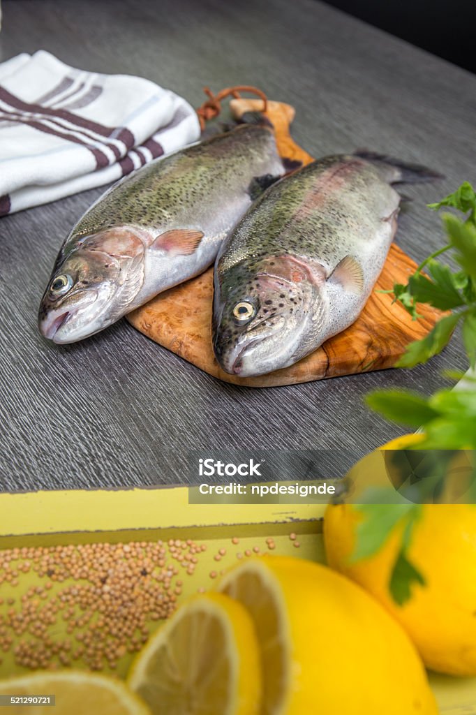 Fresh trout with lemon on a wooden tray Adult Stock Photo