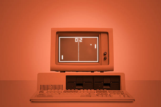 Vintage tennis videogame on old computer monitor Vintage tennis videogame on old computer monitor with coloured brown background. Retro revival of seventies devices. Copy space. Low-key background for easy costumization.  computer mainframe old retro revival stock pictures, royalty-free photos & images