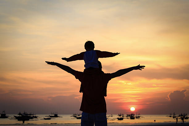 istock father and son having fun at sunset 521291957