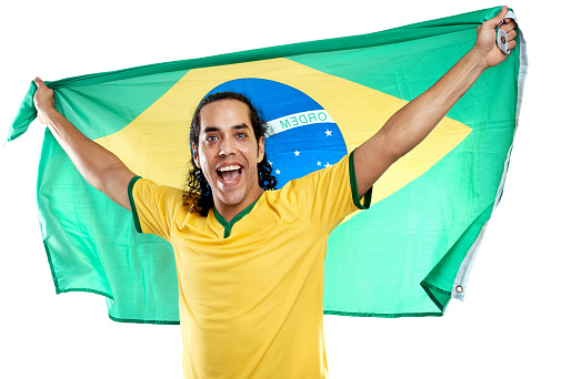 excited ecstatic fan celebrates and cheers with brasil flag for brazil football soccer world cup