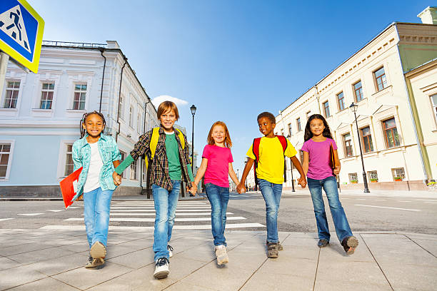 istock International schoolchildren walk and hold hands 521293421