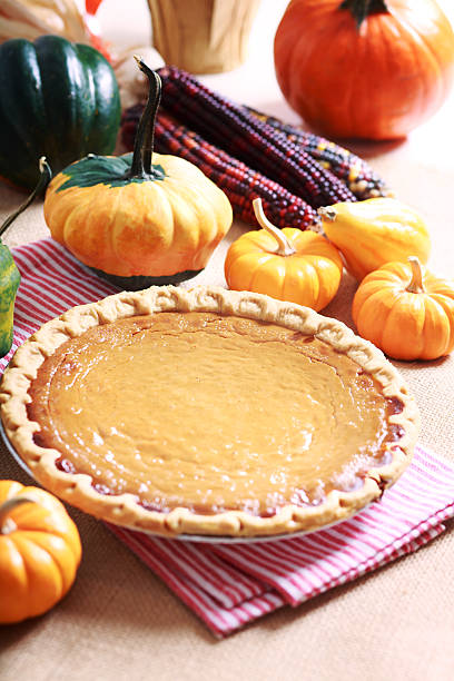 istock Pumpkin pie with autumn pumpkins and corn 521293519