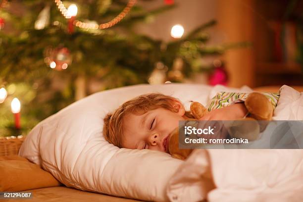 Little Cute Blond Boy Sleeping Under Christmas Tree Stock Photo - Download Image Now