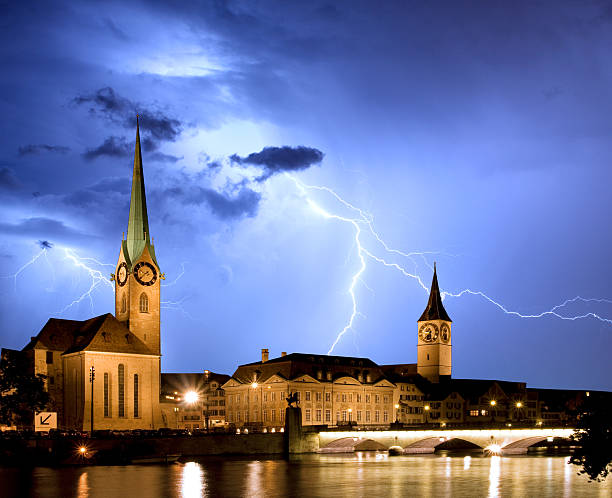 Fraumunster - Zurich with lightning Fraumunster - Zurich with lightning lightning tower stock pictures, royalty-free photos & images