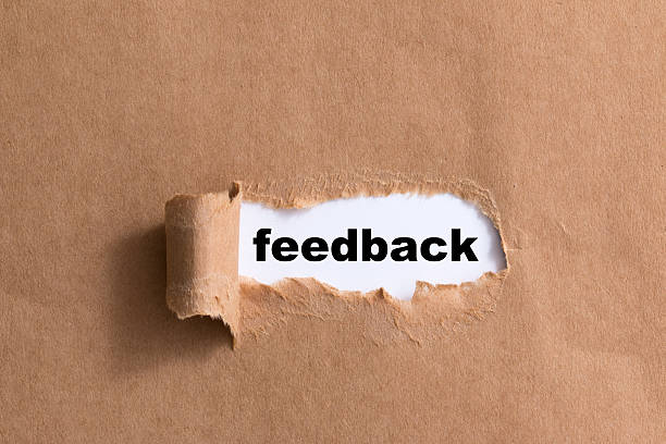 istock word feedback ,ripped paper isolated background 521295043