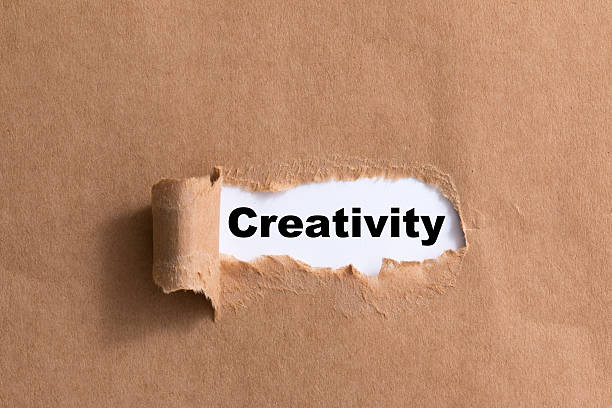 istock word creativity ,ripped paper isolated background 521295095
