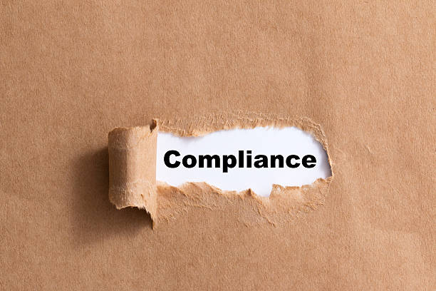 istock word compliance,ripped paper isolated background 521295117