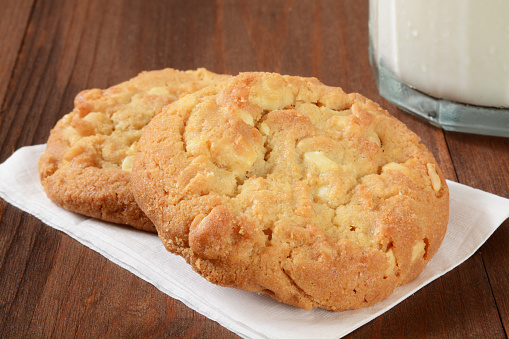 Gourmet macadamia nut cookies with a glass of milk