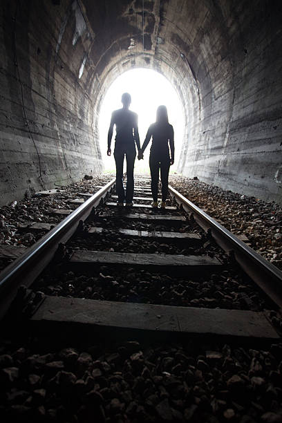 istock Couple walking together through a railway tunnel 521298902