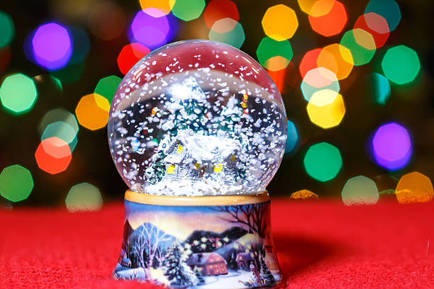natale neve globo di fronte a luci albero di natale primo piano - luminant foto e immagini stock