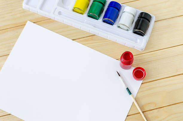 istock Blank paper with paintbrush and primary colors 521302214