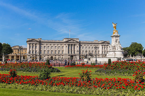 Buckingham Palace in the Summer London, UK - July 18, 2015: The outside of Buckingham Palace in London during the summer showing the Main Palace, Victoria Memorial and flowers. People can be seen outside. buckingham palace photos stock pictures, royalty-free photos & images