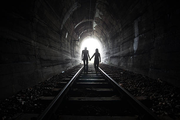 istock Couple walking together through a railway tunnel 521306072