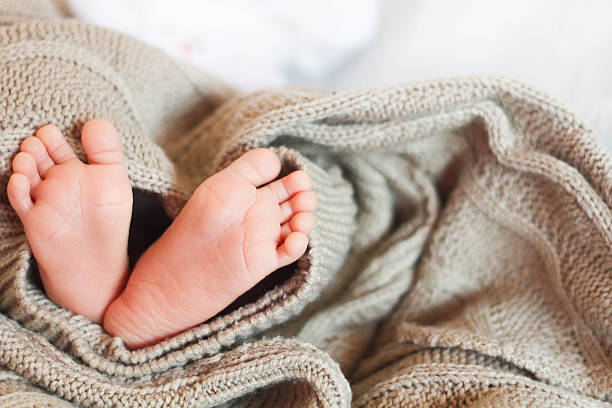 istock tiny foot of newborn baby 521306274