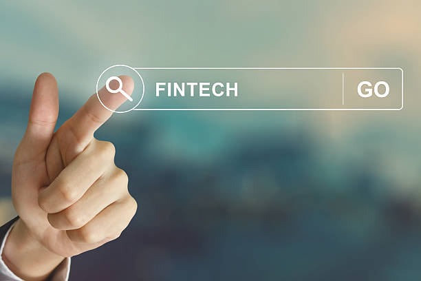 business hand clicking fintech or financial technology button stock photo