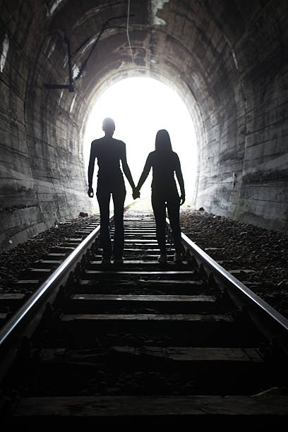 istock Couple walking together through a railway tunnel 521309010