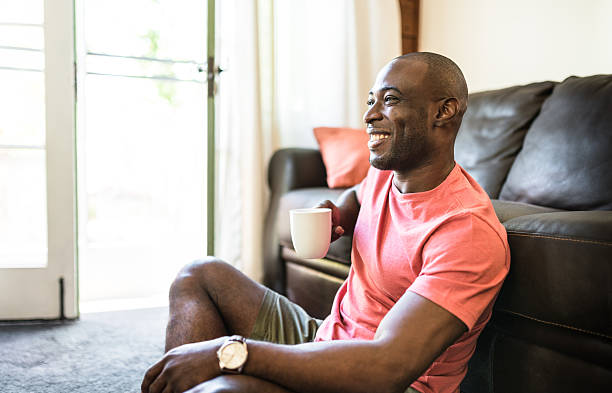 istock man realxing drinking the coffee on living room 521309744