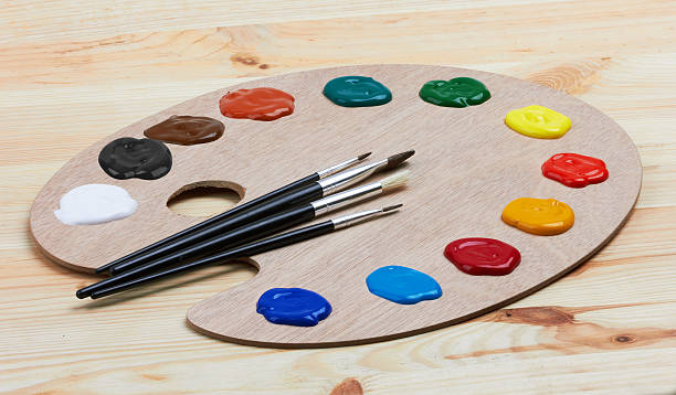 istock Wooden art palette with paints and brushes 521310432
