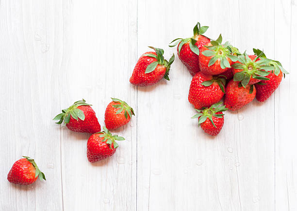Fresh strawberrieson white wooden table