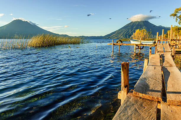 Early morning light on three volcanoes, Lake Atitlan, Guatemala stock photo