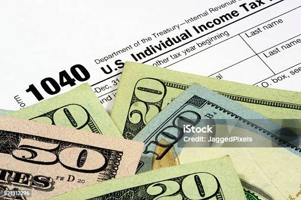 Tax Form And Currency Stock Photo - Download Image Now - Internal Revenue Service, 1040 Tax Form, Tax