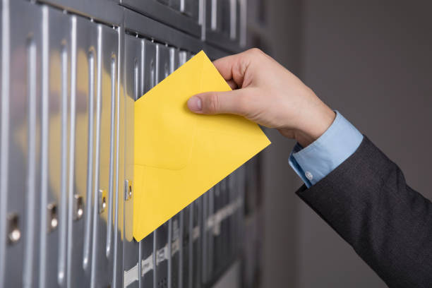 istock Mailman putting the letter into the mailbox 521312340