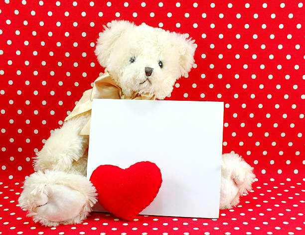 istock white card and cute teddy bear doll with red heart 521312354