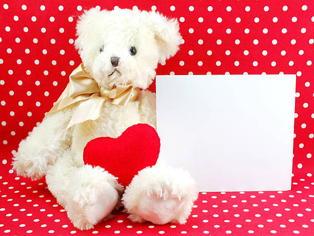 istock white card and cute teddy bear with red heart 521312558