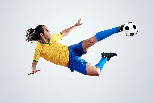 評価のゴール男性 - soccer player men flying kicking ストックフォトと画像