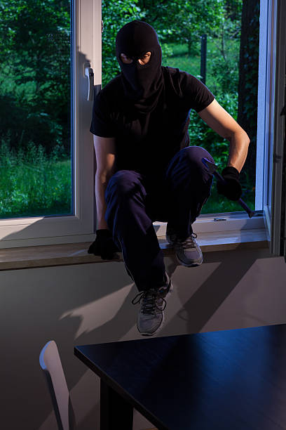 istock Criminal wants to rob a house 521315427