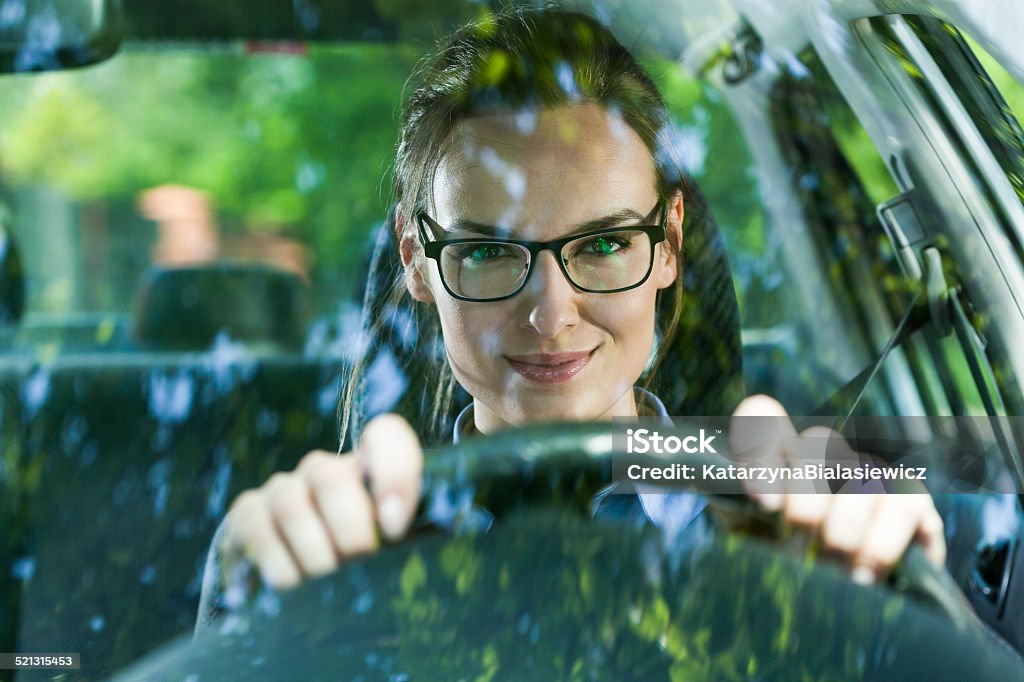 Young woman driving a car Young attractive woman in glasses driving a car Driving Stock Photo