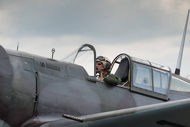 Fighter Pilot Duxford, UK - 13 July 2014:  Fighter pilot at  Duxford Flying Legends Airshow spitfire stock pictures, royalty-free photos & images