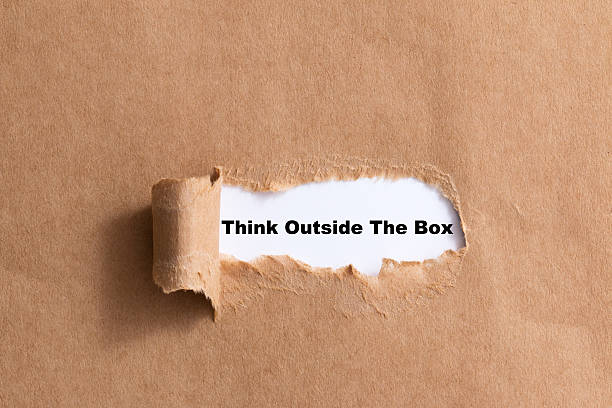 istock sentence think outside the box ripped paper isolated background 521316625