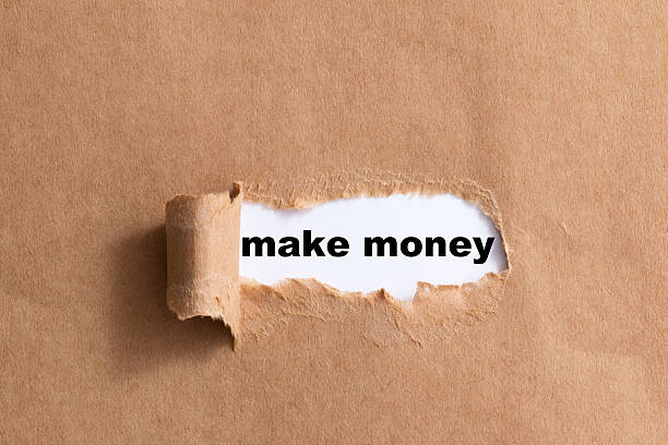 istock sentence make money on ripped paper isolated background 521316631