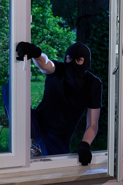 istock Masked man entering the house 521318159