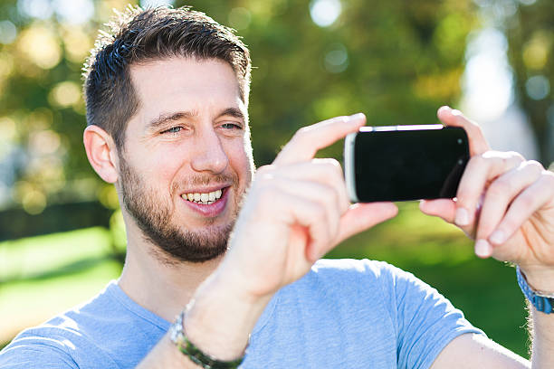 istock Young man is taking a pciture with his smart phone 521322113