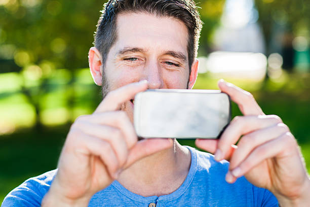istock Young man is taking a pciture with his smart phone 521322633