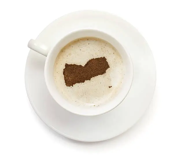 A top shot of a cup of coffee with froth and powder in the shape of Yemen (Middle).(series)   How about having a break :)