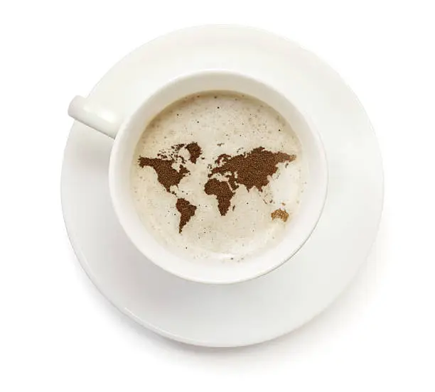 A top shot of a cup of coffee with froth and powder in the shape of World (Continent).(series)   How about having a break :)