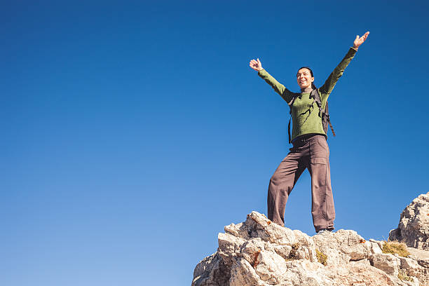 istock Woman on mountain peak 521342315