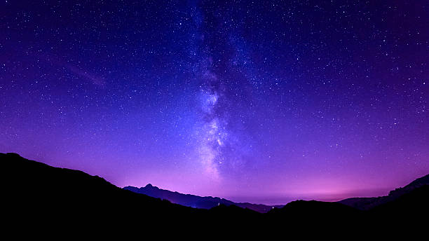 istock Milky Way Galaxy. Purple night sky stars above mountains 521343659